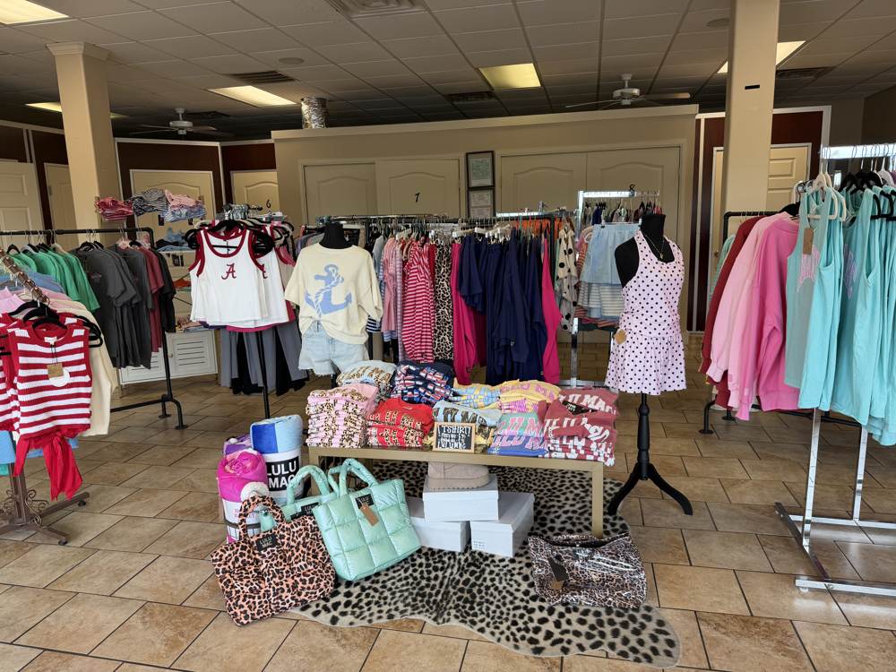 Boutique clothing racks with game day styles at Bama Tan Salon and Boutique
