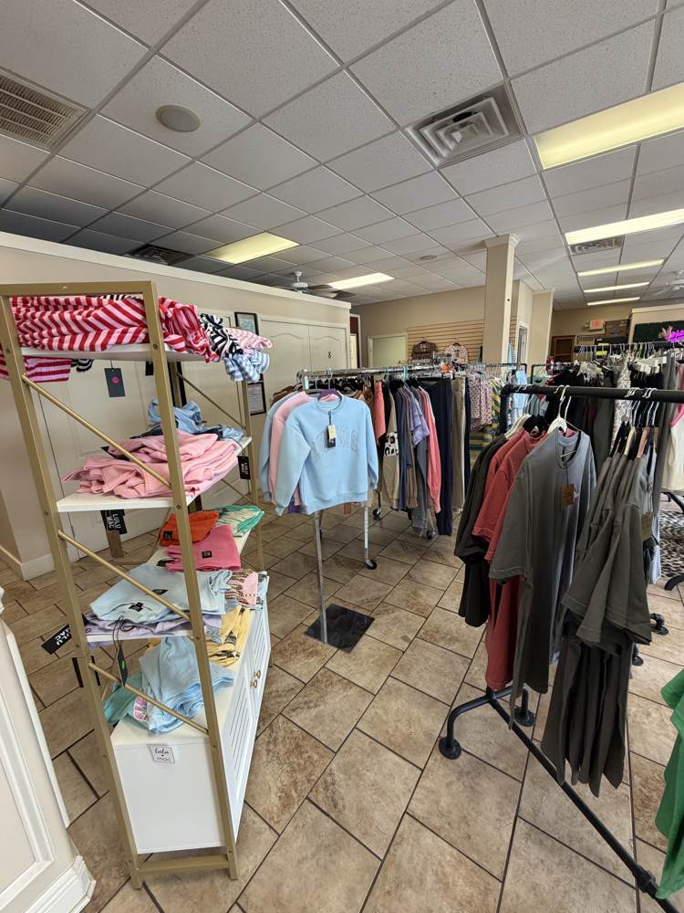 Boutique shelving with pastel sweatshirts and tees at Bama Tan Tuscaloosa