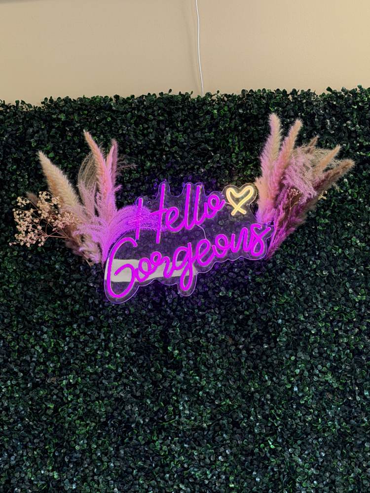 Hello Gorgeous neon sign selfie wall at Bama Tan Salon and Boutique